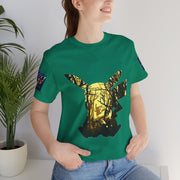 Person wearing a green t-shirt with a deer design, standing indoors next to a plant.